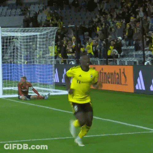 A Soccer Player In A Yellow Adidas Jersey Runs Towards The Goal GIF