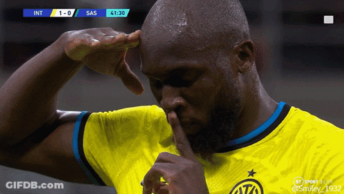 A Soccer Player In A Yellow Jersey Holds His Finger To His Nose GIF