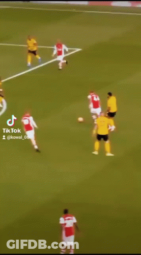 A Soccer Player In A Yellow Jersey Is Kicking A Ball GIF