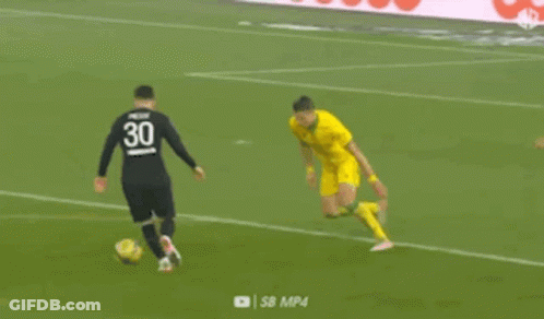 A Soccer Player In A Yellow Jersey Is Kicking A Soccer Ball On A Soccer Field . GIF