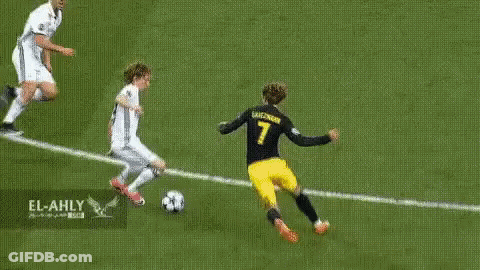 A Soccer Player In A Yellow Jersey With The Number 7 On It Is Kicking A Soccer Ball On A Soccer Field . GIF