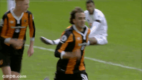 A Soccer Player In An Orange And Black Jersey With The Number 3 On The Front GIF