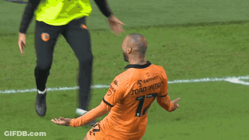 A Soccer Player In An Orange Jersey With The Number 7 On The Back GIF