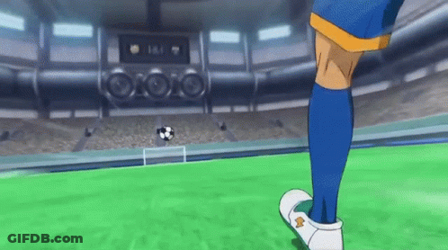 A Soccer Player In Blue Socks Is Kicking A Soccer Ball On A Field . GIF