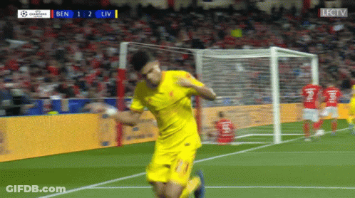 A Soccer Player In Yellow Celebrates A Goal During A Match GIF