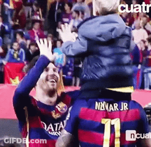 A Soccer Player Is Carrying A Child On His Shoulders And The Child Is Wearing A Number 11 Jersey . GIF