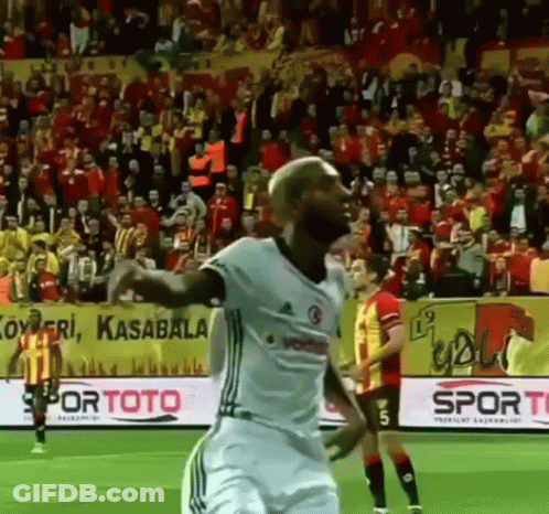 A Soccer Player Is Celebrating A Goal During A Game GIF