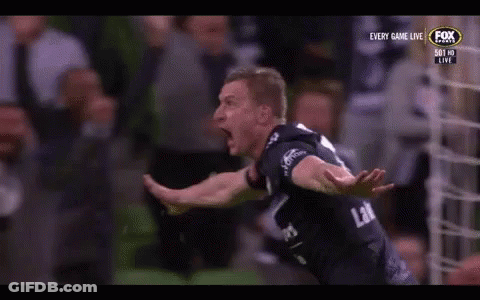 A Soccer Player Is Celebrating A Goal In Front Of A Crowd On A Television Screen . GIF