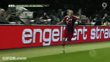 A Soccer Player Is Celebrating A Goal In Front Of A Sign That Says Engelert Stra GIF