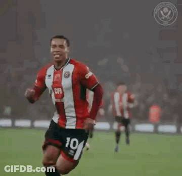 A Soccer Player Is Celebrating A Goal On A Field With His Teammates . GIF
