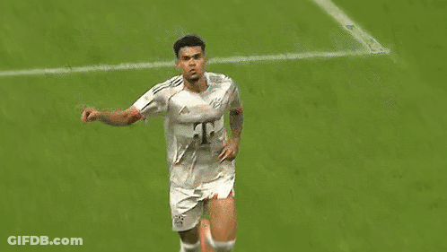 A Soccer Player Is Celebrating A Goal On The Field While Wearing A White Jersey . GIF
