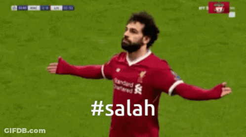 A Soccer Player Is Celebrating A Goal With A # Salah Hashtag . GIF