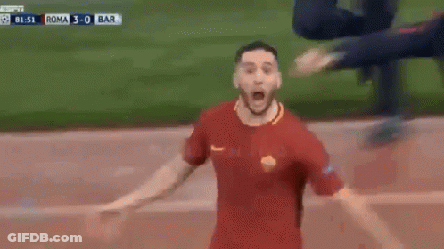 A Soccer Player Is Celebrating A Goal With His Arms Outstretched On A Soccer Field . GIF