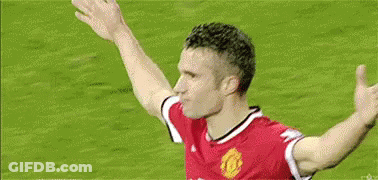 A Soccer Player Is Celebrating A Goal With His Arms Outstretched On A Soccer Field . GIF