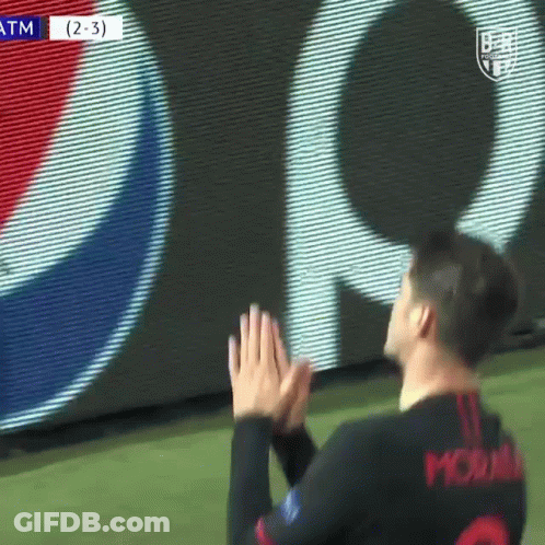 A Soccer Player Is Clapping His Hands On The Field In Front Of A Pepsi Sign . GIF