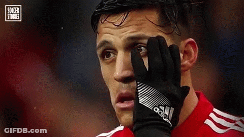 A Soccer Player Is Covering His Face With A Glove During A Match . GIF