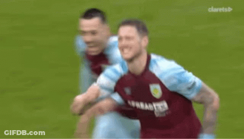 A Soccer Player Is Covering His Face With His Hand While Another Soccer Player Runs Behind Him . GIF