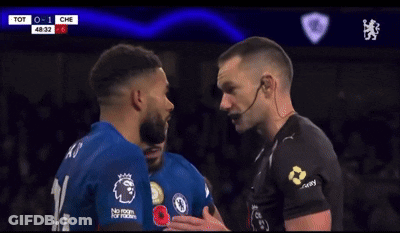 A Soccer Player Is Covering His Mouth With His Hand During A Game Between Tot And Che GIF