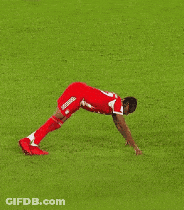 A Soccer Player Is Doing Push Ups On A Lush Green Field GIF