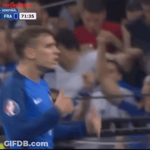 A Soccer Player Is Giving A Thumbs Up In Front Of A Crowd Of People . GIF