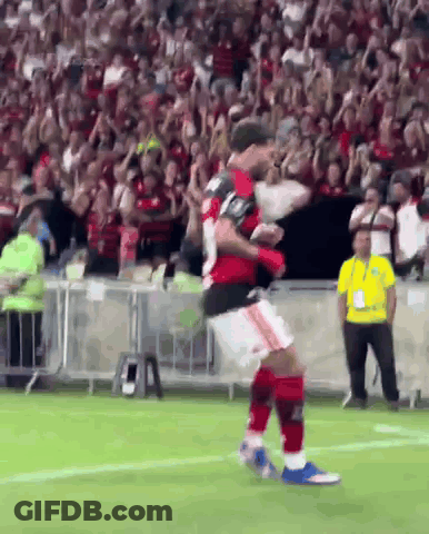 A Soccer Player Is Jumping In The Air On A Field GIF