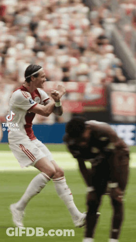 A Soccer Player Is Jumping In The Air While Another Player Watches GIF