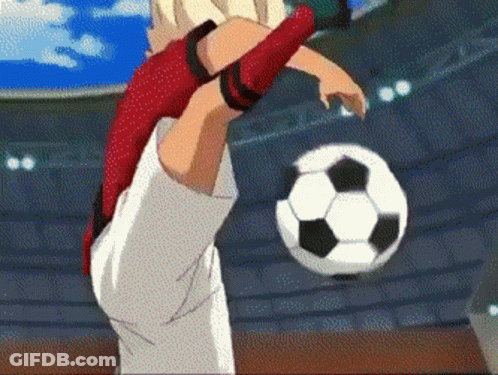 A Soccer Player Is Kicking A Ball In A Stadium GIF