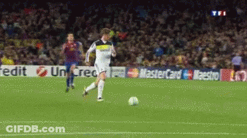 A Soccer Player Is Kicking A Ball In Front Of A Mastercard Banner GIF