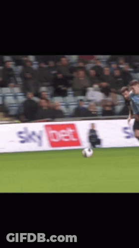 A Soccer Player Is Kicking A Ball In Front Of A Sky Bet Banner GIF