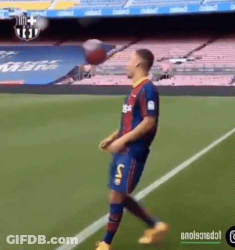 A Soccer Player Is Kicking A Ball On A Field GIF