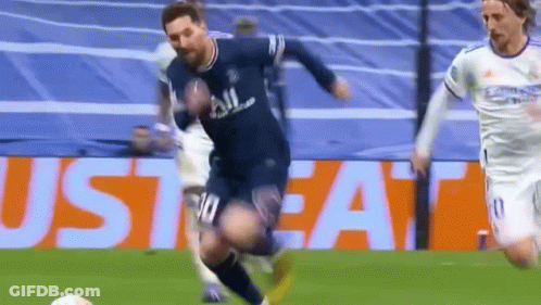 A Soccer Player Is Kicking A Soccer Ball On A Field While Another Player Watches . GIF