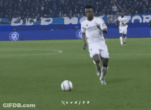 A Soccer Player Is Kicking A Soccer Ball On A Field With A Banner For Crypto.com In The Background GIF