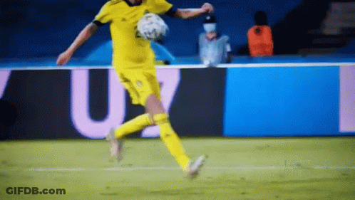 A Soccer Player Is Kicking A Soccer Ball On A Soccer Field . GIF