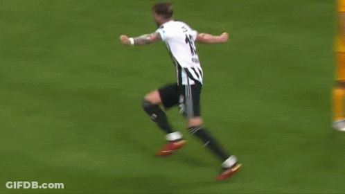 A Soccer Player Is Kneeling Down On The Field With His Arms In The Air . GIF