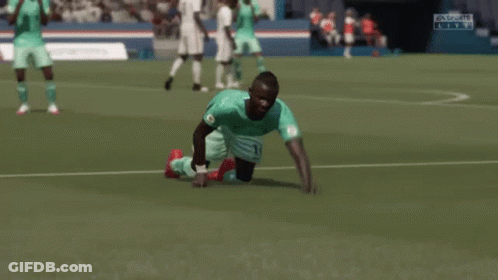 A Soccer Player Is Kneeling Down On The Field With His Arms In The Air While Another Player Kicks Him . GIF