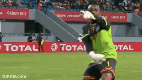 A Soccer Player Is Kneeling On The Field In Front Of A Banner That Says Total . GIF