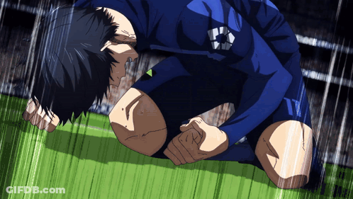 A Soccer Player Is Kneeling On The Field With A Ball On His Chest GIF