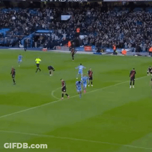 A Soccer Player Is Kneeling On The Grass With His Arms Outstretched . GIF