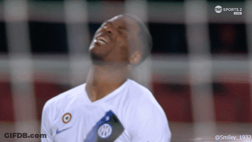 A Soccer Player Is Laughing While Wearing A White Shirt That Says Nike On It GIF