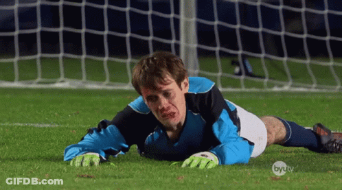 A Soccer Player Is Laying On The Field With A Byu Tv Logo In The Corner GIF
