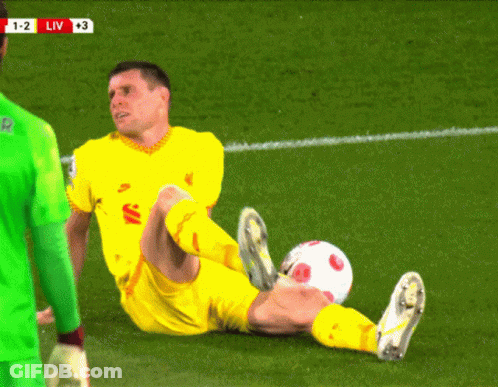 A Soccer Player Is Laying On The Field With The Score 1-2 Liv At The Top Of The Screen GIF