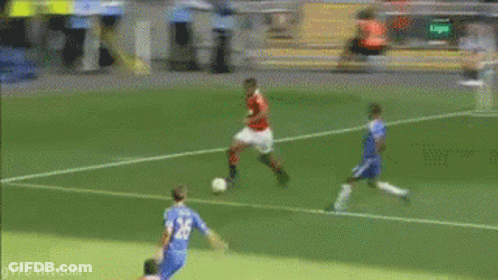 A Soccer Player Is Laying On The Ground In Front Of A Volunteers In Football Banner GIF