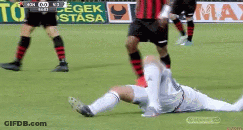 A Soccer Player Is Laying On The Ground With His Head Down GIF