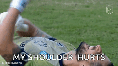 A Soccer Player Is Laying On The Ground With His Shoulder Hurting GIF