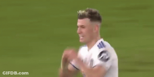 A Soccer Player Is Making A Heart Shape With His Hands While Standing On A Field . GIF