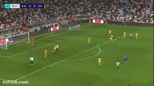 A Soccer Player Is Running On A Field During A Game . GIF