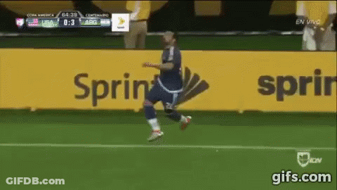 A Soccer Player Is Running On A Field In Front Of A Sprint Sign GIF