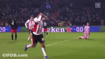 A Soccer Player Is Running On A Field With A Heineken Sign In The Background GIF