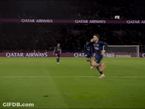A Soccer Player Is Running On A Field With Qatar Airways Advertisements In The Background GIF