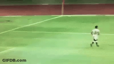 A Soccer Player Is Running On A Green Field GIF